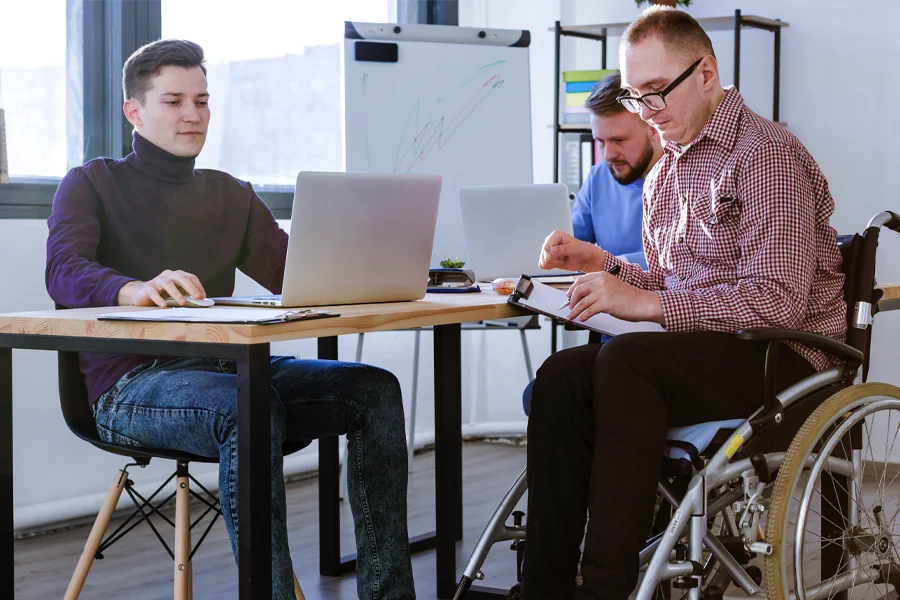 A picture of a group of people sitting together and working, in the home page section